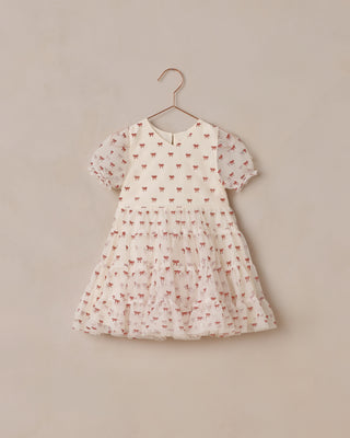 Children's dress with a subtle pattern on a beige background