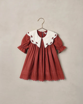 Noralee Mabel Dress in Ruby red with a scalloped ivory collar embroidered with rosebuds and puff sleeves, on a hanger