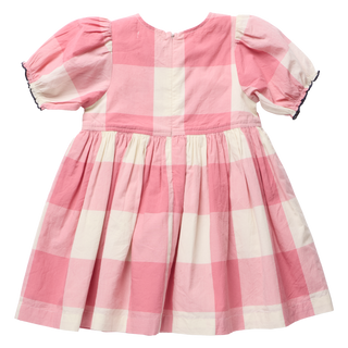 Back view of a pink and cream check dress with puff sleeves, navy ruffle trim on the cuffs, and a back zipper closure, on a white background.