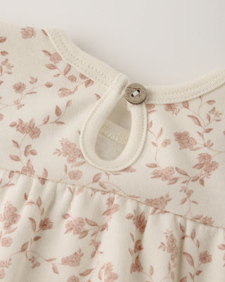 Floral patterned fabric with a button on a white background