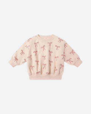 Pink sweatshirt with bow pattern on a white background