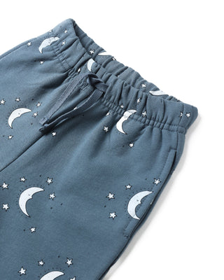 Blue pants with moon and star patterns on a white background