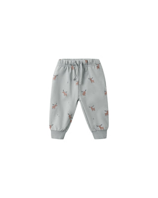 Light blue children's jogger pants with small patterns on a white background