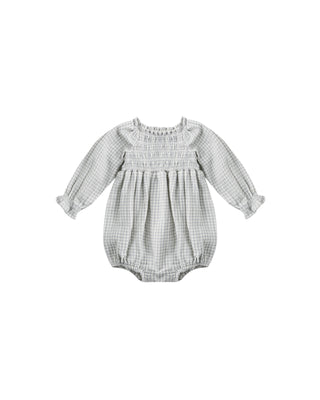 Baby romper with smocked bodice and long sleeves on a white background