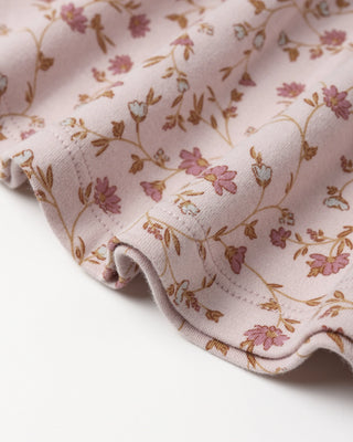 Floral-patterned fabric with pink and brown colors on a light background