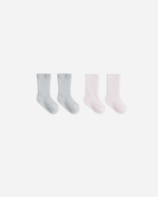 Set of four pairs of socks in gray and pink on a white background