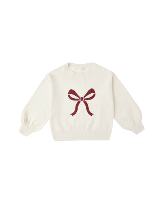 White sweater with a red bow design on a white background