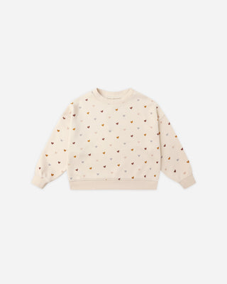 Beige sweatshirt with heart patterns on a white background