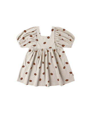 Beige dress with brown football pattern on a white background