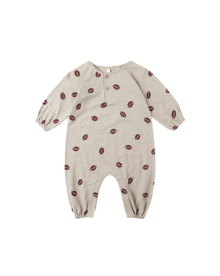 Baby onesie with red pattern on a white background