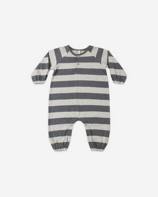 Midnight navy and cream striped long-sleeve baby romper laid flat, featuring raglan sleeves, a two-button wooden henley closure, elastic cuffs, and snap closures at the inseam.