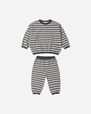Midnight navy, cream, and rust striped sweatshirt and jogger set laid flat, featuring a crew neckline, front pocket, ribbed cuffs and hem, and an elastic waistband on the pants.