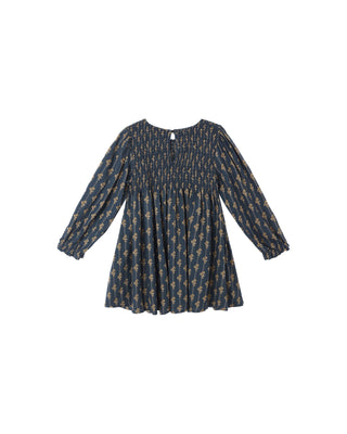 Navy blue dress with gold patterns on a white background