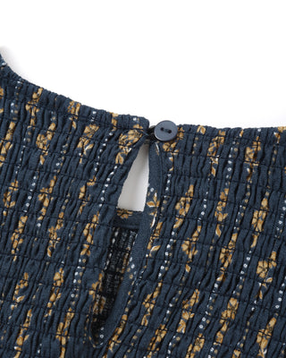 Close-up of a navy blue fabric with a subtle pattern on a white background