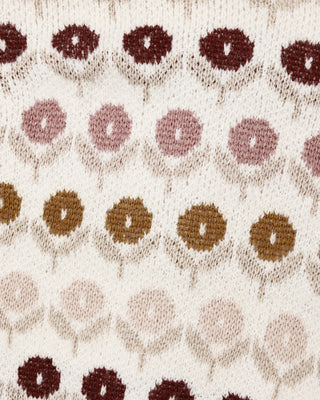 Patterned fabric with circular shapes in brown and pink on a beige background