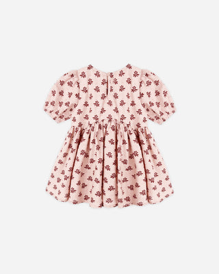 Pink dress with red floral pattern on a white background