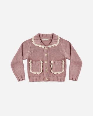 Rosewood pink knit cardigan laid flat, featuring a scalloped collar with cream trim, button-front closure, and two patch pockets with matching scalloped trim.