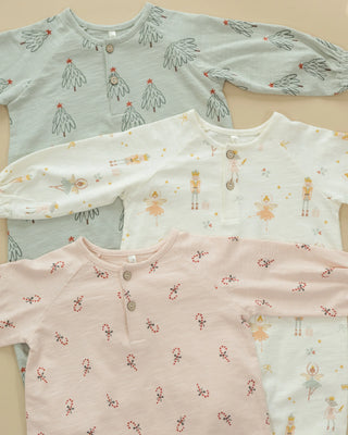 Three long-sleeve shirts with different patterns on a beige background