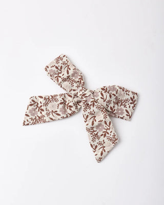 Ivory hair bow with a brown and mauve floral print, shown at an angle against a white background.