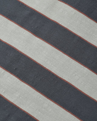 Close-up of striped fabric texture in midnight navy and cream with thin rust-red pinstripe accents.