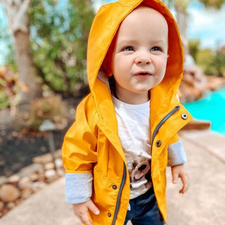 Me & Henry yellow toddler rain jacket, side view showing cotton lining